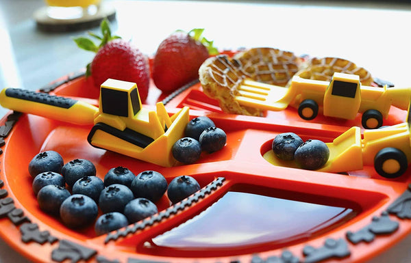 Constructive Eating bulldozer Utensil pushing blueberries onto front loader spoon. Forklift fork picking up waffles while strawberries in their own section of the plate, with maple syrup in its own divided section of the construction orange plate