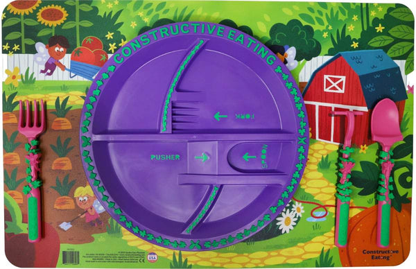 Constructive Eating dinner placement setting with purple divided plate on magical Garden Fairy placemat with utensils on shaded area on placemat